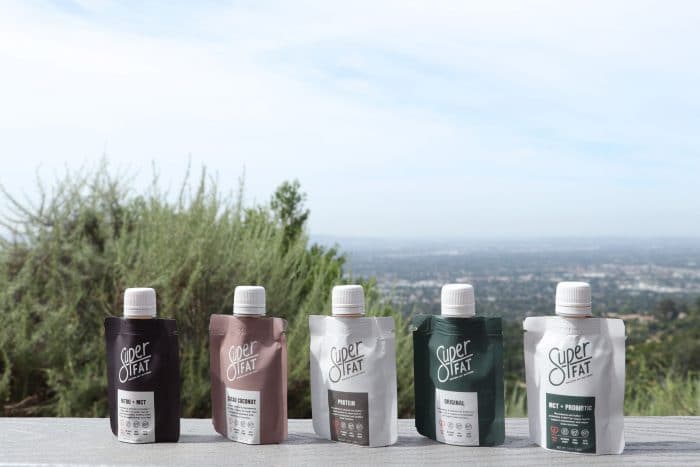 SuperFat Keto Nut Butter variety pack sitting on a concrete ledge.