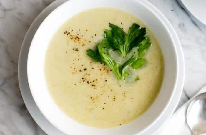 A bowl of Plant Paradox celery soup sitting on a marble surface