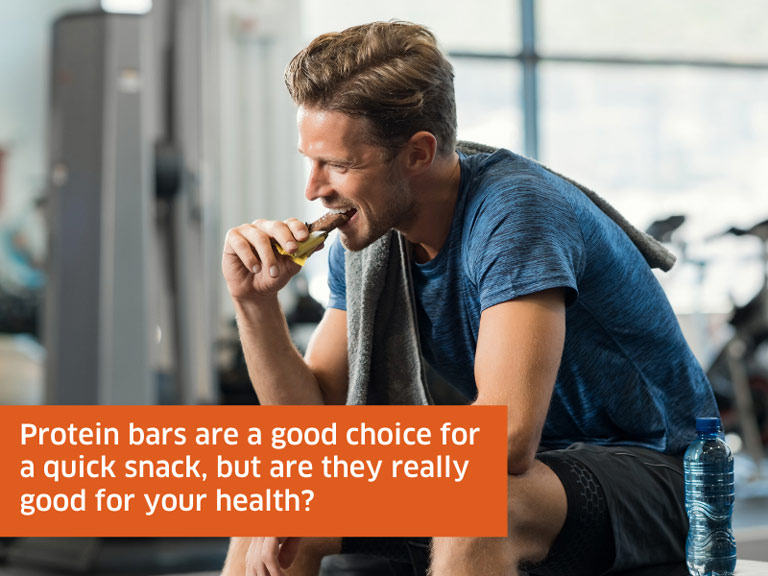 adult male eating protein bar