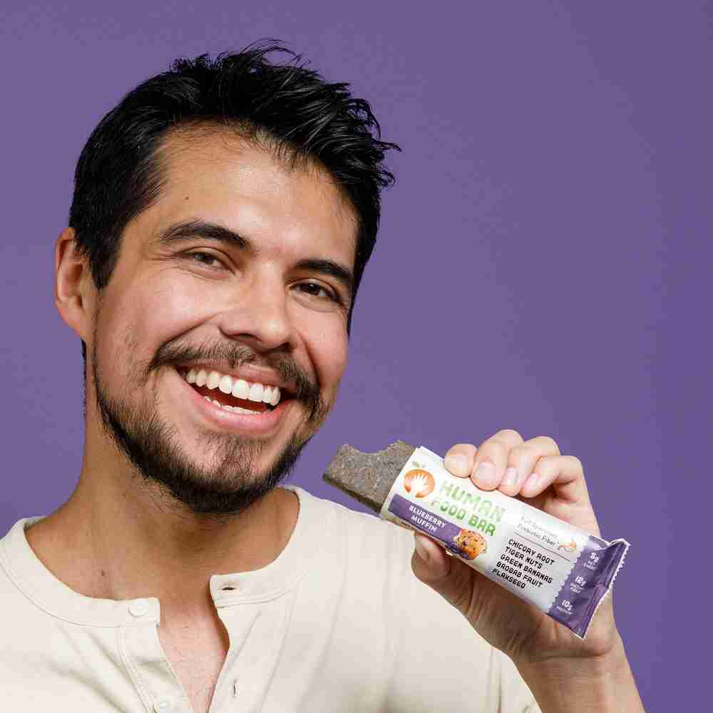Man eating blueberry muffin protein bar